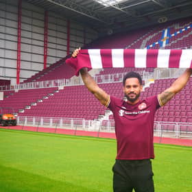 Jordan Roberts shows off his new colours  at Tynecastle after signing for Hearts.