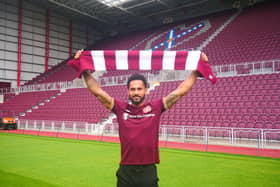Jordan Roberts shows off his new colours  at Tynecastle after signing for Hearts.