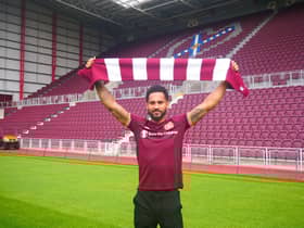Jordan Roberts shows off his new colours  at Tynecastle after signing for Hearts.