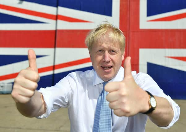 ISLE OF WIGHT, UNITED KINGDOM - JUNE 27: Conservative party leadership contender Boris Johnson poses for a photograph in front of a Union Jack on a wall at the Wight Shipyard Company at Venture Quay during a visit to the Isle of Wight on June 27, 2019 on the Isle of Wight, United Kingdom. Boris Johnson and Jeremy Hunt are the remaining candidates in contention for the Conservative Party Leadership and thus Prime Minister of the UK. Results will be announced on July 23rd 2019. (Photo by Dominic Lipinski - WPA Pool/Getty Images)