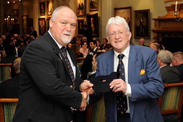 Ex-Scotland cricketer Hamish More, right, receives a special cap from MCC President Mike Gatting.