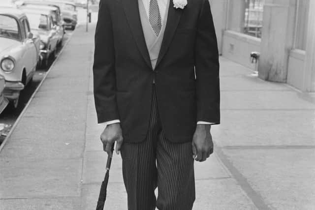 Cassius Clay donning a pin-striped suit and bowler hat ahead of his fight with Henry Cooper. Picture: Daily Express/Hulton Archive/Getty Images)