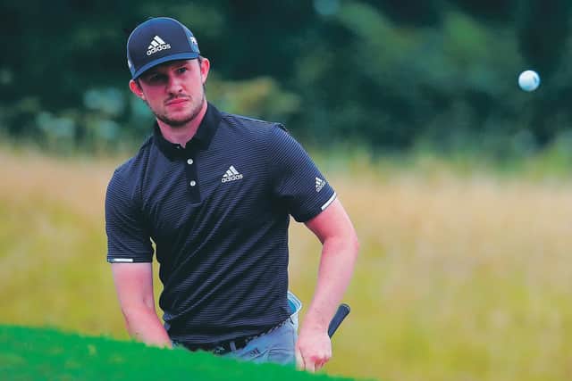 Connor Syme watches his chip shot at the 18th hole. Picture: Warren Little/Getty Images