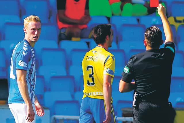 Ross Millen, left, is sent off by referee Andrew Dallas after a lunge at Scott Tanser.  Photograph: Davie Henderson