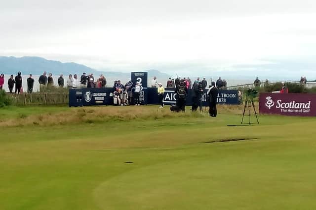 A few spectators get a glimpse of the action at Royal Troon by finding a vantage point via the adjoining beach.