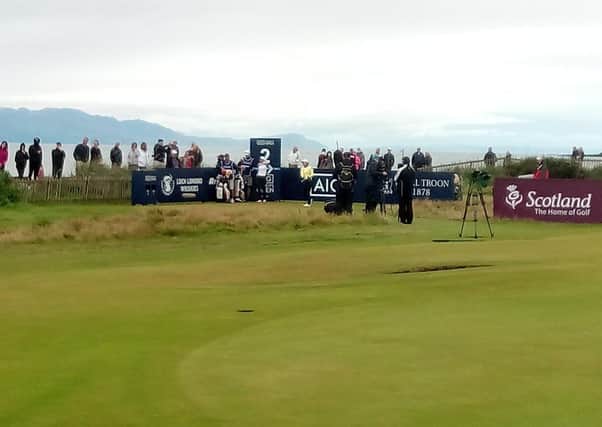 A few spectators get a glimpse of the action at Royal Troon by finding a vantage point via the adjoining beach.