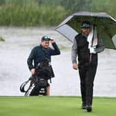 Justin Walters walks on to the 18th green amid a deluge at The Belfry. Picture: Ross Kinnaird/Getty