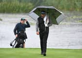 Justin Walters walks on to the 18th green amid a deluge at The Belfry. Picture: Ross Kinnaird/Getty