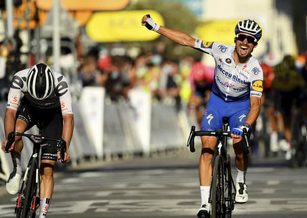 Julian Alaphilippe roars his cry of victory as he crosses the line to win Stage 2 of the Tour de France. Picture: AP