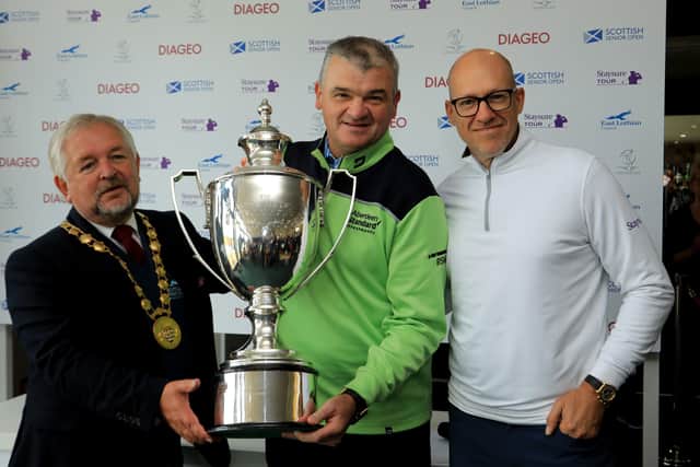 Paul Lawrie, flanked by John McMillan, provost of East Lothian, left, and Ryan Howson, after the Scot had won the Scottish Senior Open at Craigielaw Golf Club last year. Picture: Getty