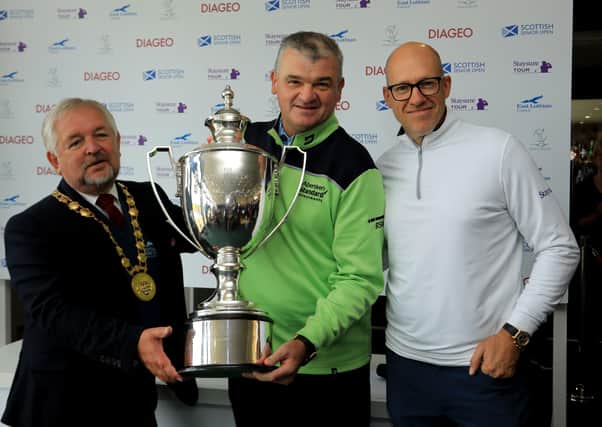 Paul Lawrie, flanked by John McMillan, provost of East Lothian, left, and Ryan Howson, after the Scot had won the Scottish Senior Open at Craigielaw Golf Club last year. Picture: Getty