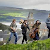 (Left to right) Shaun Bythell, Ben Porter, Beth Porter and Jane Baldwin, at Wigtown's Martyr's Stake in Wigtown Bay. They will all be launching Wigtown Book Festival. Picture: Colin Hattersley/Wigtown Book Festival Company/PA Wire