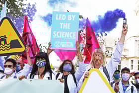 Extinction Rebellion protesters make the point that their calls for greater action are backed by scientists (Picture: Luciana Guerra/PA Wire)