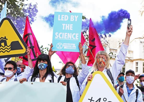 Extinction Rebellion protesters make the point that their calls for greater action are backed by scientists (Picture: Luciana Guerra/PA Wire)