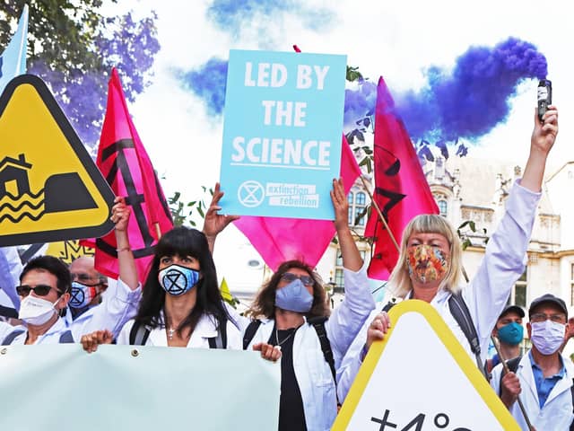 Extinction Rebellion protesters make the point that their calls for greater action are backed by scientists (Picture: Luciana Guerra/PA Wire)