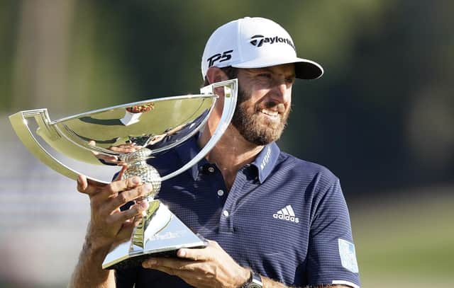 Dustin Johnson holds the FedEx Cup trophy aloft after winning the Tour Championship at Lake Golf Club in Atlanta on Monday. Picture: John Bazemore/AP