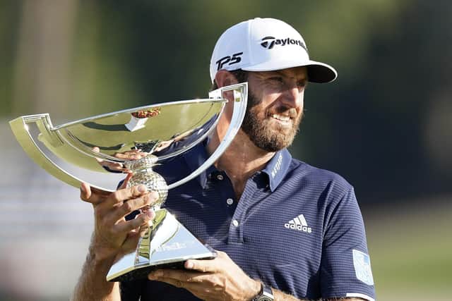 Dustin Johnson holds the FedEx Cup trophy aloft after winning the Tour Championship at Lake Golf Club in Atlanta on Monday. Picture: John Bazemore/AP