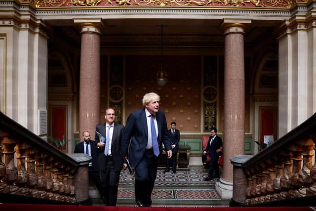 Prime Minister Boris Johnson climbs the stairs on his way to his weekly Cabinet meeting in the Locarno Room inside the Foreign Office. Picture: Andrew Parsons/No 10 Downing Street