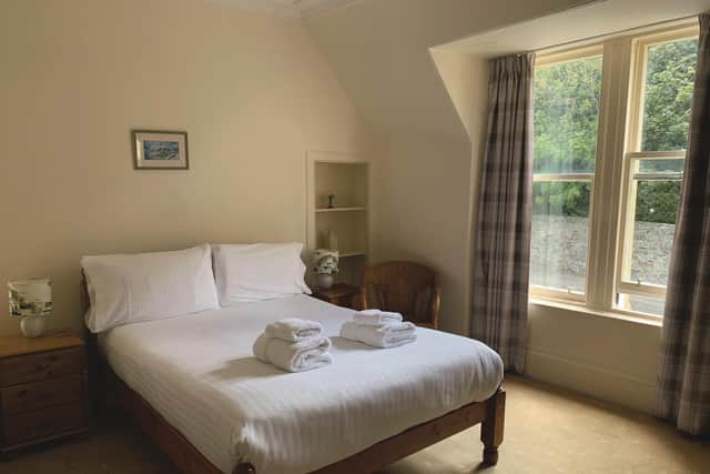 Subtle tartan drapes in one of the eight bedrooms, some of which are sea-facing while others look onto the Victorian viaduct that used to run the railway line along the coast.