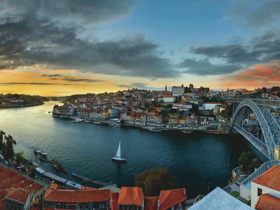 The red roofs of downtown Porto and the Douro River at sunset.