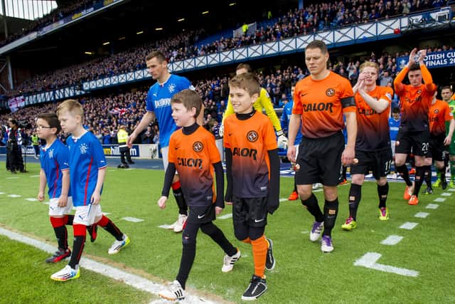 The teams emerge from the Ibrox tunnel the last time Rangers and Dundee United played, in 2014. Picture: Sammy Turner/SNS
