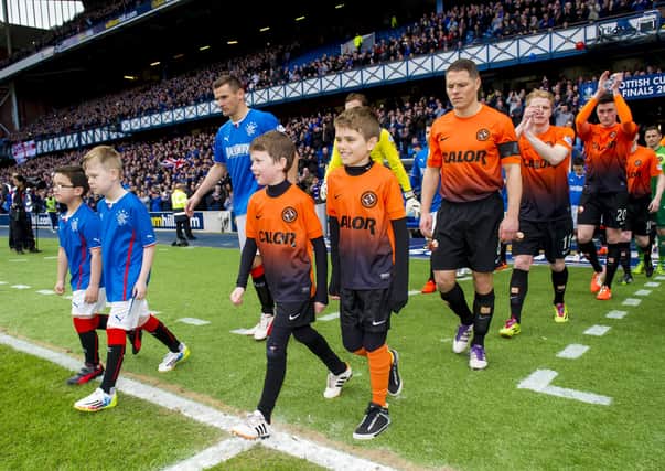 The teams emerge from the Ibrox tunnel the last  time Rangers and Dundee United played, in 2014.  Picture: Sammy Turner/SNS