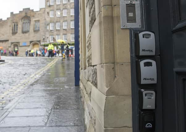 Key safes, at a block of flats in Edinburgh, 
are a tell-tale sign of short-term let properties (Picture: Ian Rutherford)