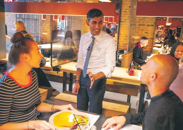 Rishi Sunak serves customers at Wagamama without a mask.  Picture: Simon Walker/
HM Treasury