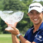 Collin Morikawa celebrates with the winner's trophy after winning the Workday Charity Open