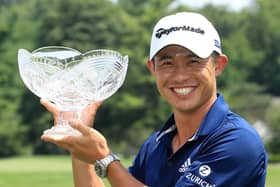 Collin Morikawa celebrates with the winner's trophy after winning the Workday Charity Open