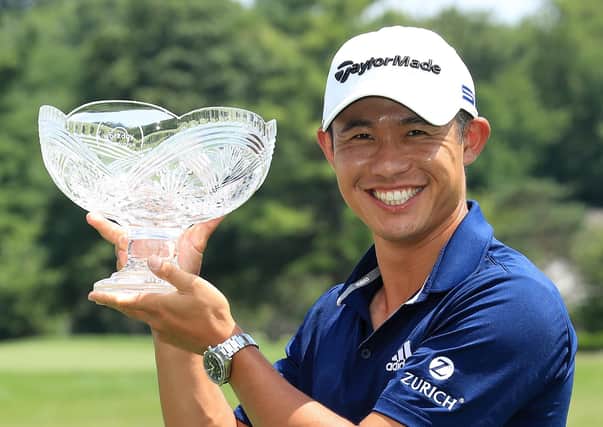 Collin Morikawa celebrates with the winner's trophy after winning the Workday Charity Open