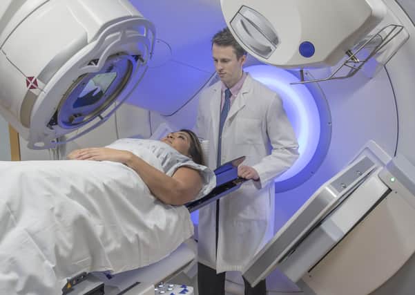 A woman receiving radiation therapy treatments for breast cancer