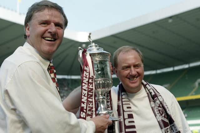 Jim Jefferies and assistant Billy Brown celebrate with the Scottish Cup after Hearts' 2-1 win over Rangers in the 1998 final.