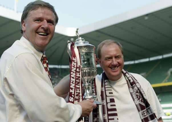 Jim Jefferies and assistant Billy Brown celebrate with the Scottish Cup after Hearts' 2-1 win over Rangers in the 1998 final.