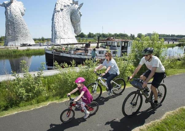Families exploring the Falkirk Wheel and Kelpies along NCN Route 754.