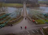 Members of the public cross the Union Bridge on the River Tweed