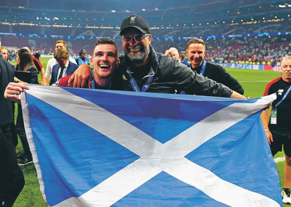 Andy Robertson smiles and Jurgen Klopp flashes his cartoon gnashers after Liverpool’s 2019 Champions League win. Picture: Andrew Powell/Getty Images