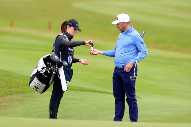 Tournament host Lee Westwood and girlfriend caddy Helen Storey use hand sanitiser during the Betfred British Masters at Close House. Picture: Mike Egerton/PA Wire