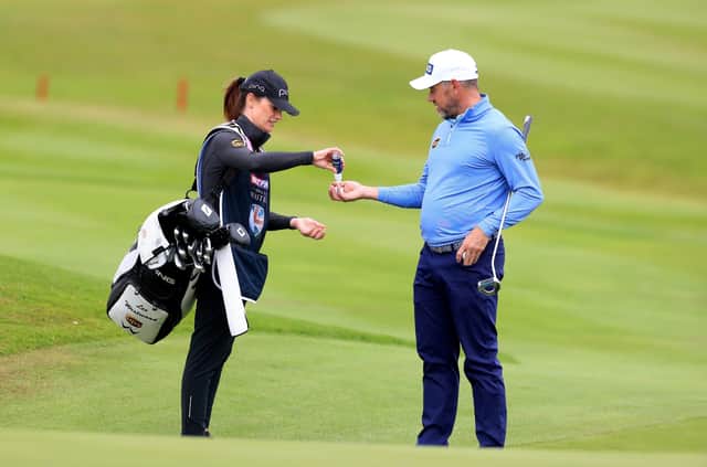 Tournament host Lee Westwood and girlfriend caddy Helen Storey use hand sanitiser during the Betfred British Masters at Close House. Picture: Mike Egerton/PA Wire