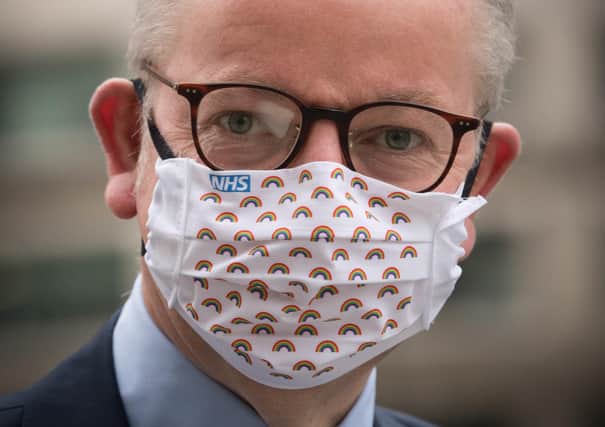 Michael Gove, seen wearing an NHS face mask, described protesters against people heading north the Scotland-England border as 'bampots' (Picture: Stefan Rousseau/PA Wire)