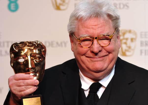 Film director, producer and writer Alan Parker poses with his BAFTA fellowship award in 2013 (Picture Carl Court/AFP via Getty Images)