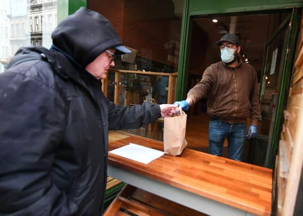 Picture : John Devlin 17/04/2020. GLASGOW. Social Bite, 103 St Vincent St, Glasgow G2 5EA.  Euan Brock (29) shop manager hands out lunch to the homeless.  https://www.justgiving.com/fundraising/joshua-littlejohn  Workers at Social Bite are working through the lockdown to feed the homeless. They prepare food onsite and then deliver to 20 locations around Glasgow.   Working today are staff members Joe Burke 50 (delivery driver) Euan Brock (29) shop manager, Lauren Garnish (26) assistant manager and Matthew Taylor (34) chef.  Help Social Bite deliver free food nationwide during COVID-19 outbreak Story UPDATE: THE DEMAND FOR FREE FOOD PACKS IS GETTING LARGER EACH DAY. WE HAD AN INITIAL TARGET OF PRODUCING 3000 FOOD PACKS PER DAY BUT DUE TO DEMAND WE ARE NOW DISTRIBUTING 4000 FOOD PACKS PER DAY AND WE EXPECT THIS TO RISE AS THE CRISIS DEEPENS. WE NEED YOUR SUPPORT TO HELP US  SCALE-UP THIS VITAL SERVICE.    Hello, I am Josh, the co-founder of Social Bite.  I want to tell you about how we have been affected by the