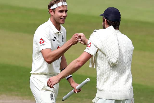 England's star bowlers Stuart Broad and Chris Woakes, right, celebrate after clinching victory over the West Indies at Old Trafford. Picture: Martin Rickett/NMC Pool/PA Wire
