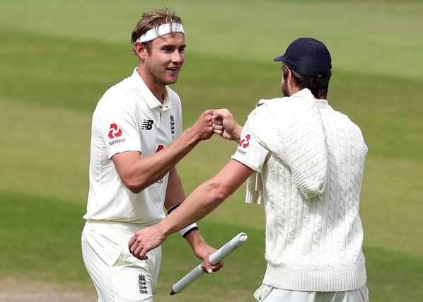 England's star bowlers Stuart Broad and Chris Woakes, right, celebrate after clinching victory over the West Indies at Old Trafford. Picture: Martin Rickett/NMC Pool/PA Wire