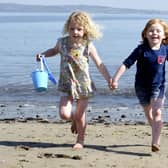 Polly Smith and Daisy Tolmie, both aged five, enjoy the warm weather at W
ardie Bay. Picture: Lisa Ferguson