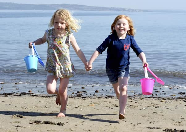 Polly Smith and Daisy Tolmie, both aged five, enjoy the warm weather at W
ardie Bay. Picture: Lisa Ferguson