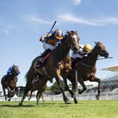 Fancy Blue and jockey Ryan Moore, left, prove too strong in the finish as they win the Nassau Stakes. Picture: Edward Whitaker/PA Wire