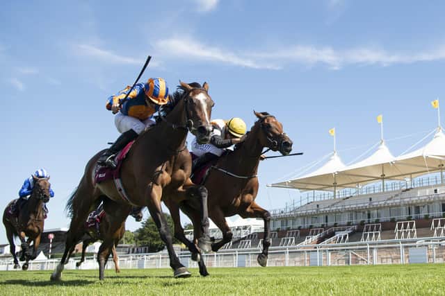 Fancy Blue and jockey Ryan Moore, left, prove too strong in the finish as they win the Nassau Stakes. Picture: Edward Whitaker/PA Wire