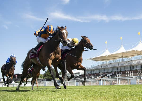 Fancy Blue and jockey Ryan Moore, left, prove too strong in the finish as they win the Nassau Stakes. Picture: Edward Whitaker/PA Wire