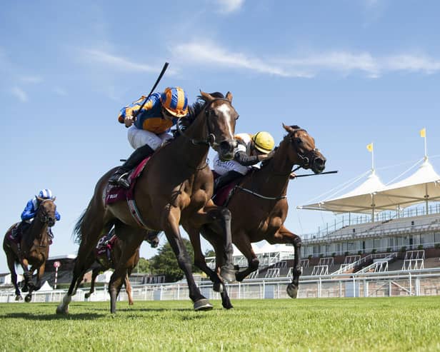 Fancy Blue and jockey Ryan Moore, left, prove too strong in the finish as they win the Nassau Stakes. Picture: Edward Whitaker/PA Wire